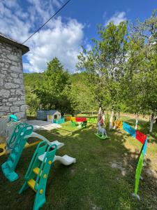 a group of people playing in a playground at LOPATE mountain stone house in Lopate