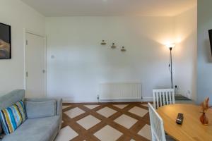 a living room with a couch and a table at Great offers on Long Stays!! LaLuNa Apartments in Gateshead