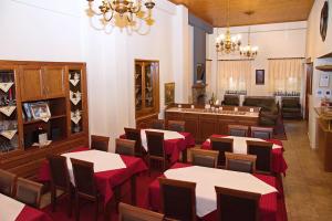 a dining room with tables and chairs in a restaurant at Hotel Filoxenia in Portaria