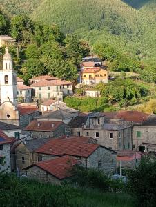 a group of buildings in a town with a church at La Antica Torre in Sasseta
