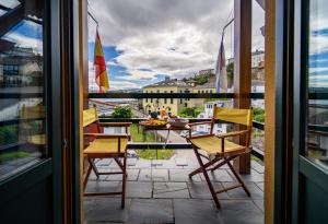 a balcony with chairs and a view of a city at Hotel A. G. Porcillan in Ribadeo