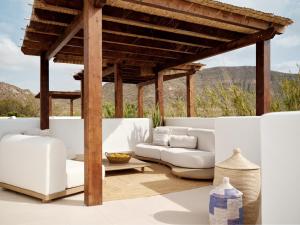 a living room with a white couch and a pergola at Hotel Los Patios - Parque Natural in Rodalquilar