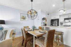 a kitchen and dining room with a table and chairs at 1327 Pelican Watch Villa in Seabrook Island