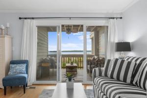 a living room with a couch and a sliding glass door at 1327 Pelican Watch Villa in Seabrook Island