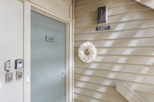 a wreath on the side of a house with a door at 1327 Pelican Watch Villa in Seabrook Island
