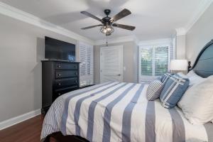 a bedroom with a bed and a ceiling fan at 1307 Pelican Watch Villa in Seabrook Island