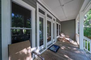 a porch with a chair and windows on a house at 1006 Crooked Oaks in Seabrook Island