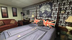 a bedroom with a bed with british flags on it at Medley Manor in East Peoria