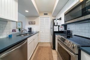 a kitchen with a sink and a stove top oven at 1304 Pelican Watch Villa in Seabrook Island