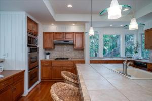 a kitchen with wooden cabinets and a large kitchen island at 2710 Gnarled Pine in Seabrook Island