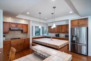 a kitchen with wooden cabinets and a stainless steel refrigerator at 2710 Gnarled Pine in Seabrook Island