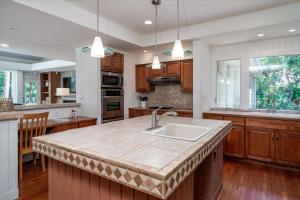 a kitchen with a large island with a sink at 2710 Gnarled Pine in Seabrook Island