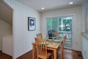 a dining room with a wooden table and chairs at 2710 Gnarled Pine in Seabrook Island +25 photos