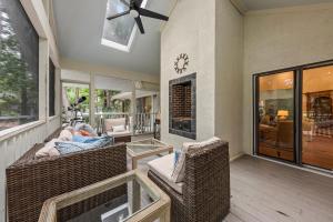 a living room with wicker chairs and a fireplace at 2565 The Haul Over in Seabrook Island