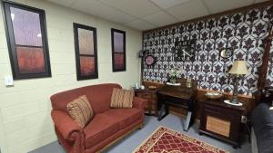 a living room with a red couch and a desk at Medley Manor in East Peoria +122 photos