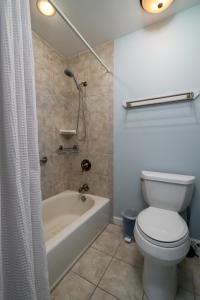 a bathroom with a tub and a toilet and a shower at 1905 Bohicket Marina in Seabrook Island +21 photos