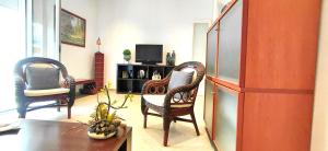 a living room with two chairs and a table at APARTAMENTO ISAMAR in Calella