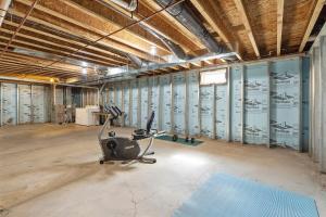 a room with a gym with exercise equipment in it at Cozy Corner in Oswego