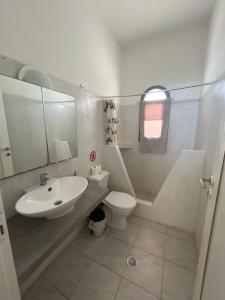 a bathroom with a sink and a toilet at Leon Lux Apartment in Perivolos
