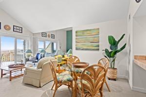 a living room with a couch and a table and chairs at 1340 Pelican Watch Villa in Seabrook Island