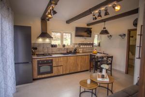 a kitchen with wooden cabinets and a table and chairs at Kuća za odmor Olea in Stari Grad +37 photos