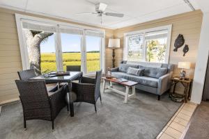 a living room with a couch and a table and chairs at 1806 Heron Point in Summerville