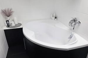 a bathroom with a white sink with a faucet at Apartmán u pilotky in Poděbrady