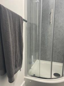 a shower with a glass door and two towels at Jayden house in Middlesbrough