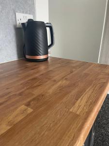 a black coffee pot sitting on top of a wooden table at Jayden house in Middlesbrough