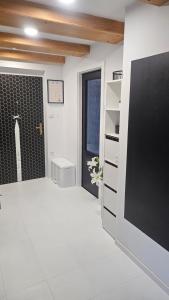 a bathroom with a toilet and a black and white wall at Apartmán u pilotky in Poděbrady