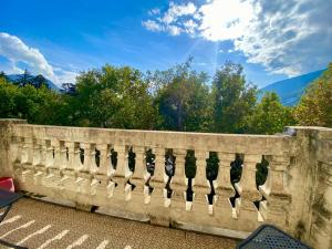 a stone fence with trees in the background at Spazioso e accogliente nel centro di Merano in Merano +18 photos