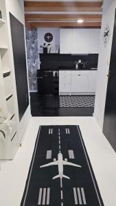 a kitchen with a runway rug on the floor at Apartmán u pilotky in Poděbrady