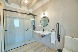a bathroom with a shower and a sink at Apartamentos La Gruta de Aracena 3 in Aracena +75 photos