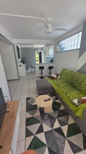 a living room with a couch and a table at Villa El Gato in Bouillante