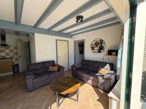 a living room with two couches and a table at Verba in Hollum