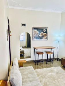 a living room with a table and two chairs at Robchen homes in Entebbe