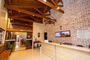 a restaurant with a brick wall and a counter at Rancho das Pedras Itaberá in Itaberá