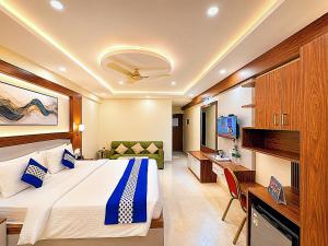 a hotel room with a large bed and a television at Blue Lily Beach Resort in Puri