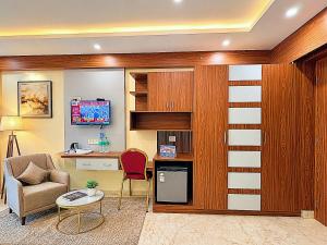 a living room with a desk and a chair at Blue Lily Beach Resort in Puri