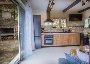 a kitchen with wooden cabinets and a fireplace at Kuća za odmor Olea in Stari Grad
