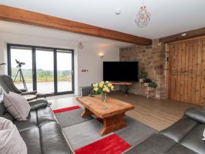 a living room with a couch and a coffee table at Ploughman's Rigg in Harrogate