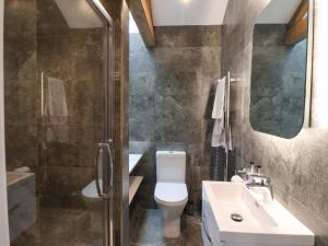 a bathroom with a toilet and a sink and a shower at Ploughman's Rigg in Harrogate +28 photos