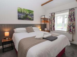 a bedroom with a large bed and a window at Ploughman's Rigg in Harrogate
