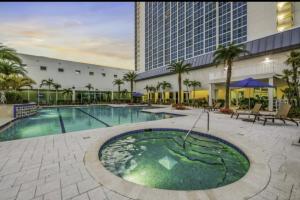 a swimming pool in a resort with a building at Luxury II in Fort Myers