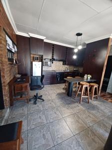 a kitchen with a table and some chairs and a counter at Duncan Garden Cottage in Brakpan