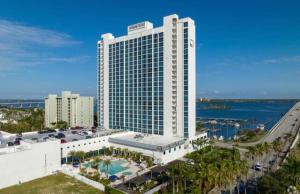 a large white building with a pool in front of it at Luxury II in Fort Myers