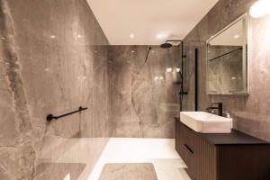 a bathroom with a sink and a shower at Hotel Monte Sereno in Zonza
