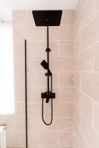 a shower with a shower head in a bathroom at Casa Bubela- Vía de la plata in Dozón