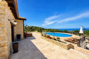 a patio with a swimming pool and a building at Bellapais Stone Villa in Kyrenia