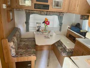 a small kitchen with a table in a tiny caravan at Sequoia National Forest Glamping in Posey